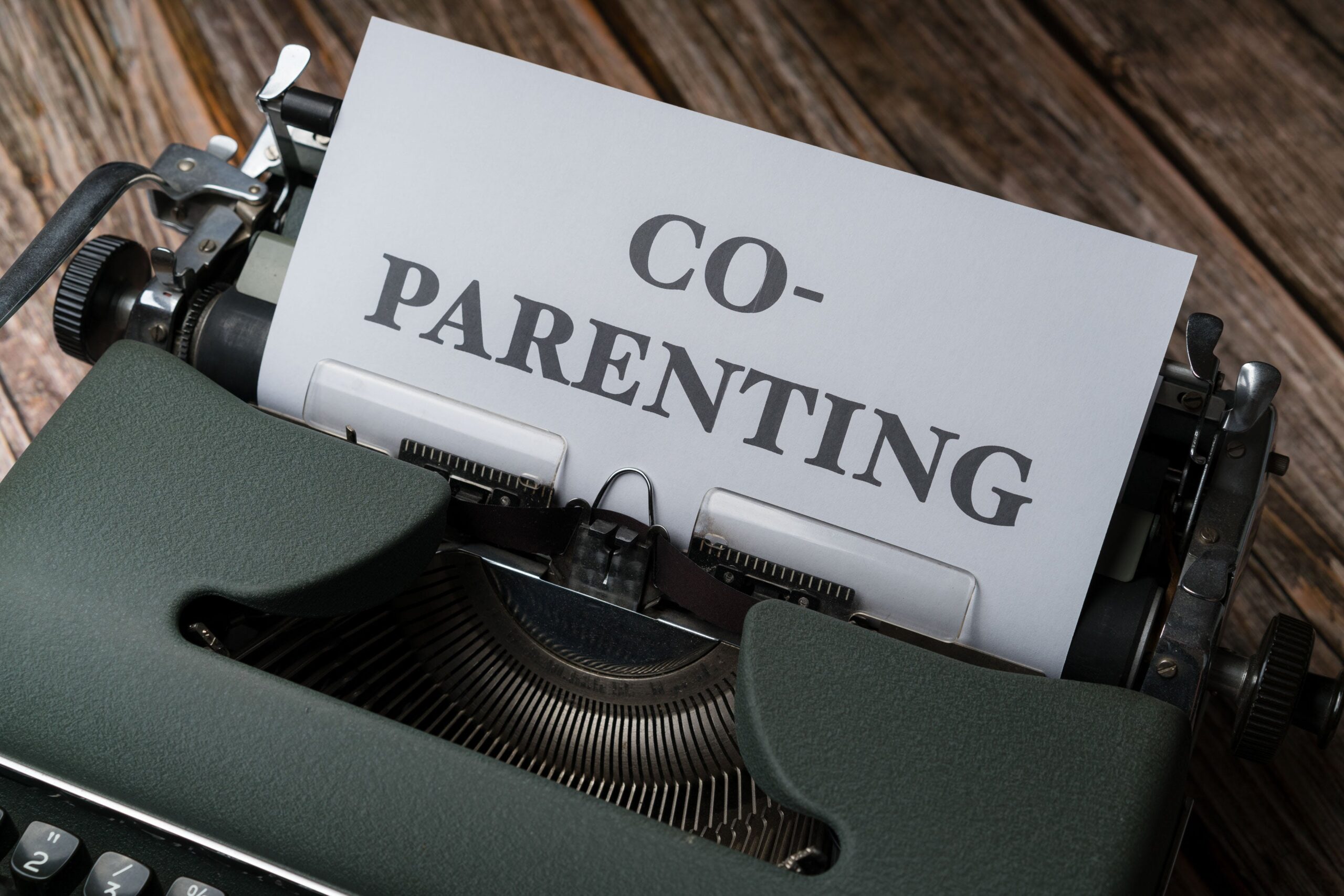 A typewriter with the word co parenting written on it