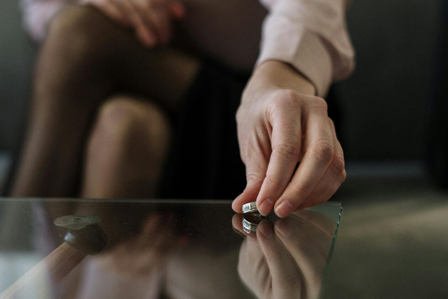 Person in white long sleeve shirt holding silver and black scissors